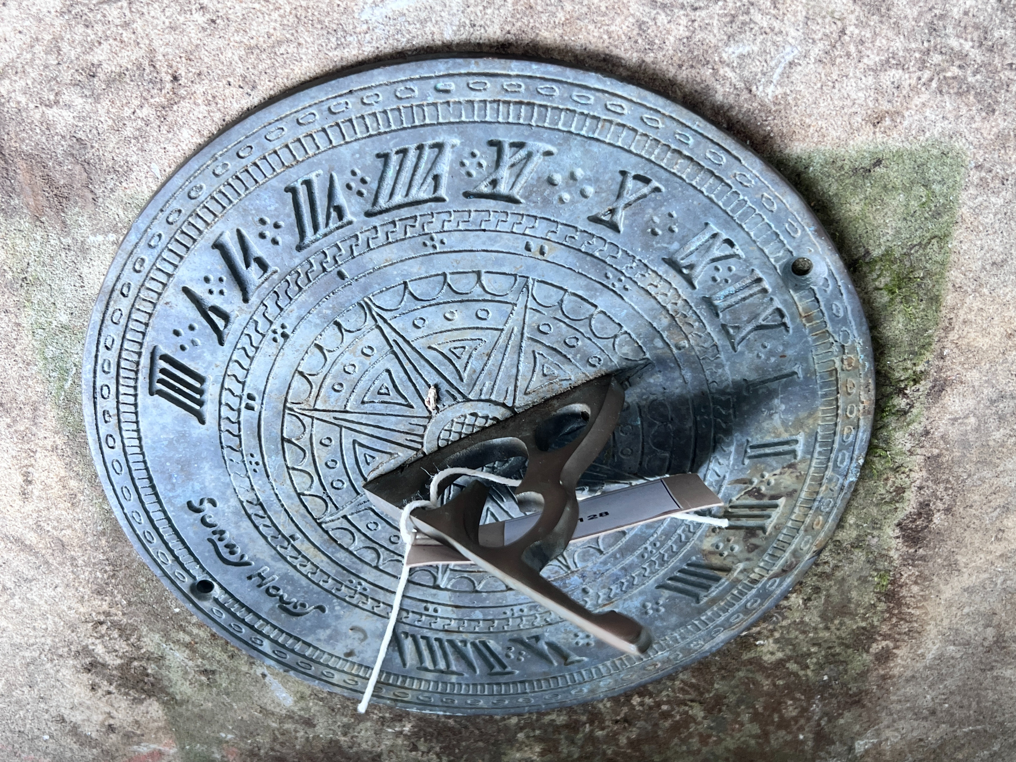 A sectional carved stone sundial with cast brass scale and gnomon, height 96cm